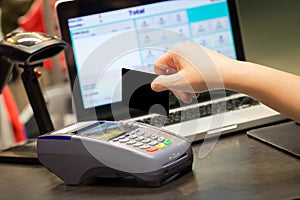 Hand With Credit Card Swipe Through Terminal For Sale photo