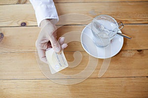 Hand with credit card to pay in cafe