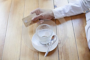 Hand with credit card to pay coffee