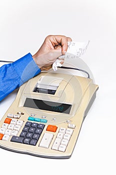 Hand crumples paper check over cash register on white background