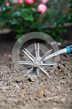 Hand cultivator cultivates the land close-up