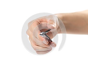 The hand cuts the nails with wire cutters on the hand. On a white background