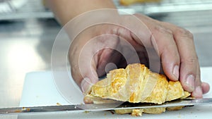 Hand cutting croissant