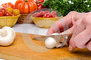 Hand cutting a mushroom
