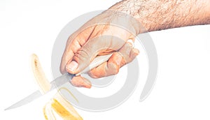 Hand cutting a banana