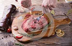 Hand cutting raw beef steak