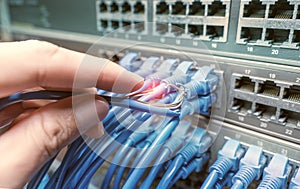 hand with damaged stranded network cable