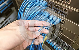 Hand with damaged stranded network cable