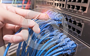 hand with damaged stranded network cable