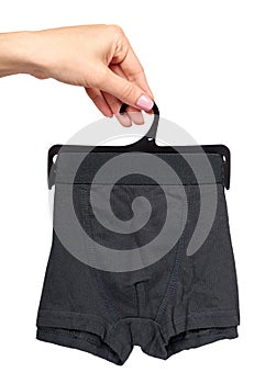 Hand with dark boxer underwear, cotton pants