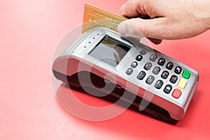Hand with dataphone paying and charging with credit card