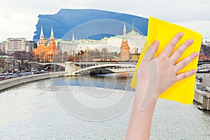 Hand deletes morning Moscow view by yellow cloth