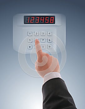 Hand dialling on touch keypad photo