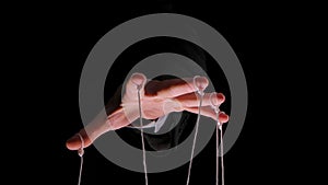 Hand of dictator in a business suit with strings on the fingers to control the puppet. Close up male hand with strings