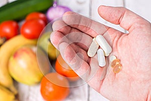 Hand with dietary supplements. photo