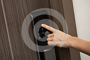 Hand and digital smart code lock into the modern apartment