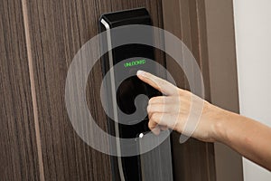 Hand and digital smart code lock into the modern apartment
