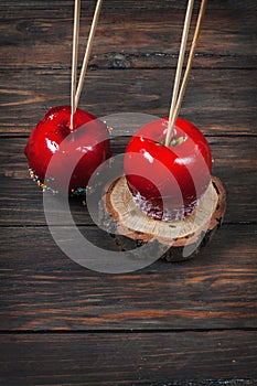 Hand dipped caramel apple covered with multi color sprinkles