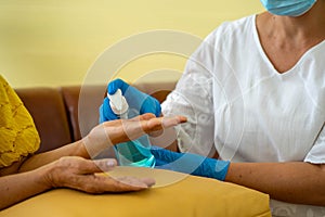 Hand disinfection with alcohol  in hospital with daughter taking care with protective face mask.  Health care and medicine concept