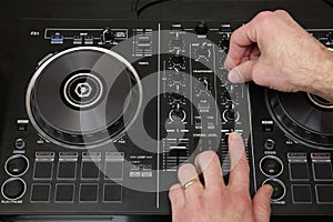 Hand of dj in action. Music background, banner. Modern technologies