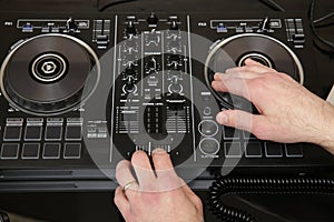Hand of dj in action. Music background, banner. Modern technologies