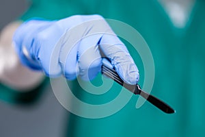 Hand of doctor holding scalpel