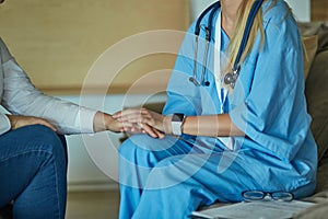 Hand of doctor reassuring her female patient