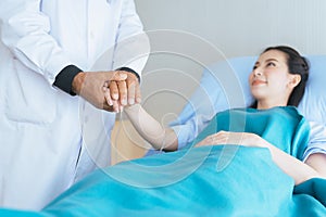 Hand doctor reassuring woman patient in hospital room,Doctor giving a consultation and encouragement to patient,Mental healt