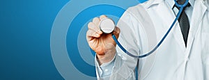 Hand Of Doctor With A Stethoscope On Blue Background. Healthcare Medicine Concept