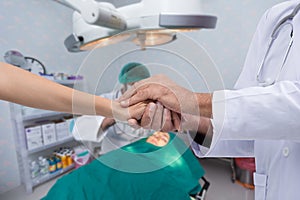 Hand of doctors to reassuring relatives of the patient