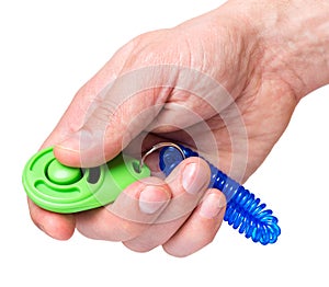 Hand with dog clicker on white