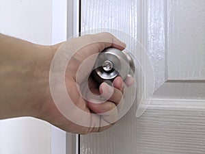 Hand on door knobs, Open door knobs