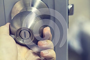 Hand on door knobs, Open door knobs