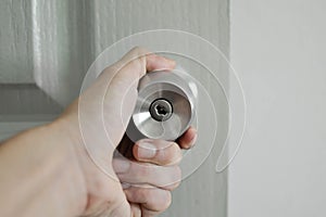 Hand on door knobs. Stainless door knob