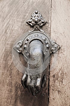 Hand Doorknocker on allwood door.