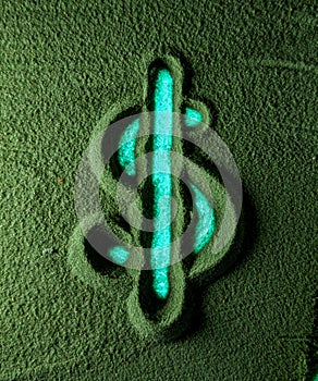 Hand drawing the Dollar currency symbol in the Green Sand.