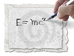 Hand drawing E=mc2 on paper