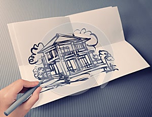Hand drawing house on white folding paper background