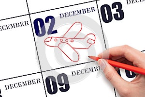 A hand drawing outline of airplane on calendar date 2 December. The date of flight on plane.