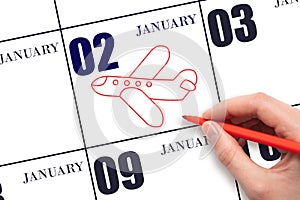 A hand drawing outline of airplane on calendar date 2 January. The date of flight on plane.