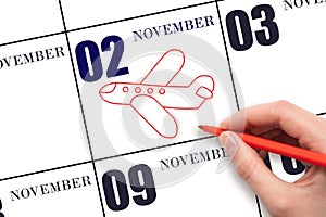 A hand drawing outline of airplane on calendar date 2 November. The date of flight on plane.