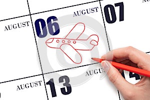 A hand drawing outline of airplane on calendar date 6 August. The date of flight on plane.