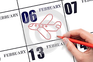 A hand drawing outline of airplane on calendar date 6 February. The date of flight on plane.