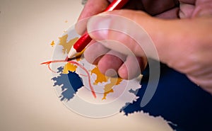 Hand drawing a red line between the UK and Northern Ireland, Backstop and Brexit concept.