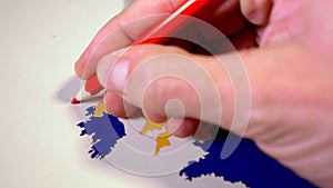 Hand drawing a red line between the UK and Northern Ireland, Backstop and Brexit concept.