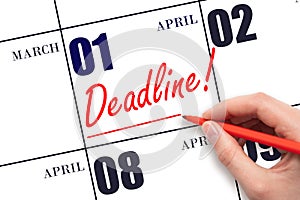 Hand drawing red line and writing the text Deadline on calendar date April 1. Deadline word written on calendar