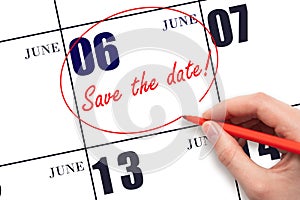 Hand drawing red line and writing the text Save the date on calendar date June 6.