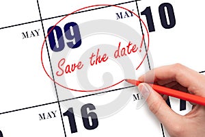 Hand drawing red line and writing the text Save the date on calendar date May 9.