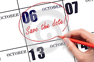 Hand drawing red line and writing the text Save the date on calendar date October 6.