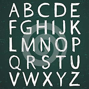 Hand-drawn alphabet. Calligraphy font. Modern chalk lettering. Letters on the green board